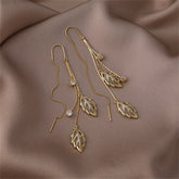 Stunning gold leaf ear threaders adorned with crystal stones, crafted in Cats Eye & 18K gold plating for a chic look.